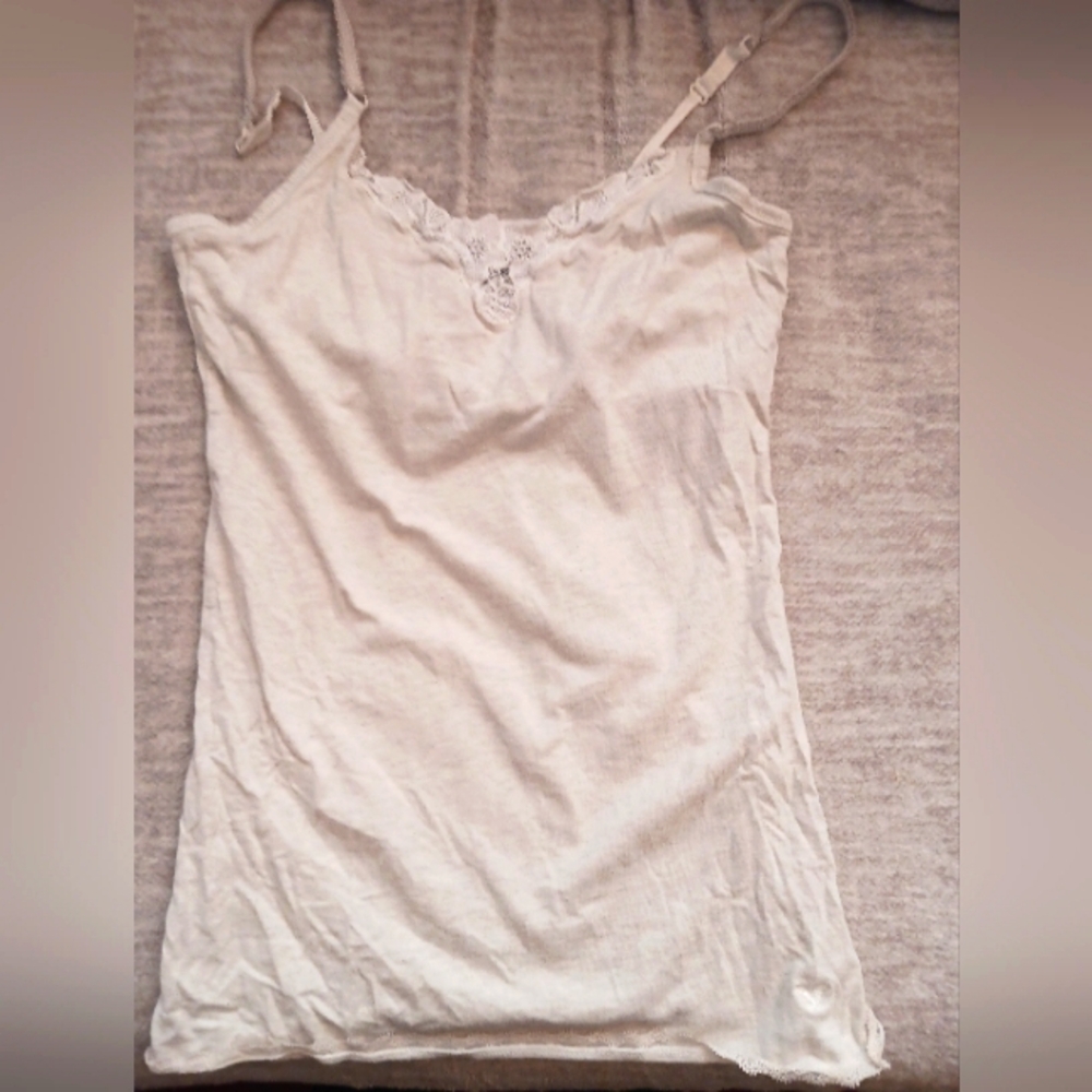 Small, older American eagle white tank top with floral decal on chest